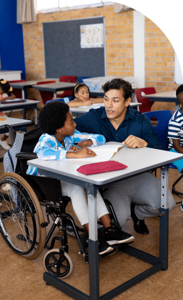 Teacher teaching student with disability