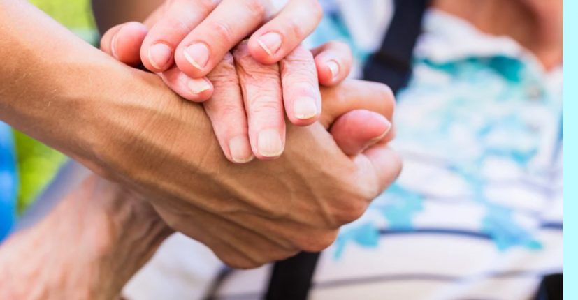 a young hand holding an old hand