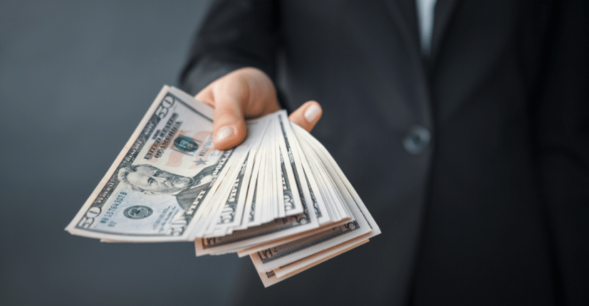 person handing money to another person